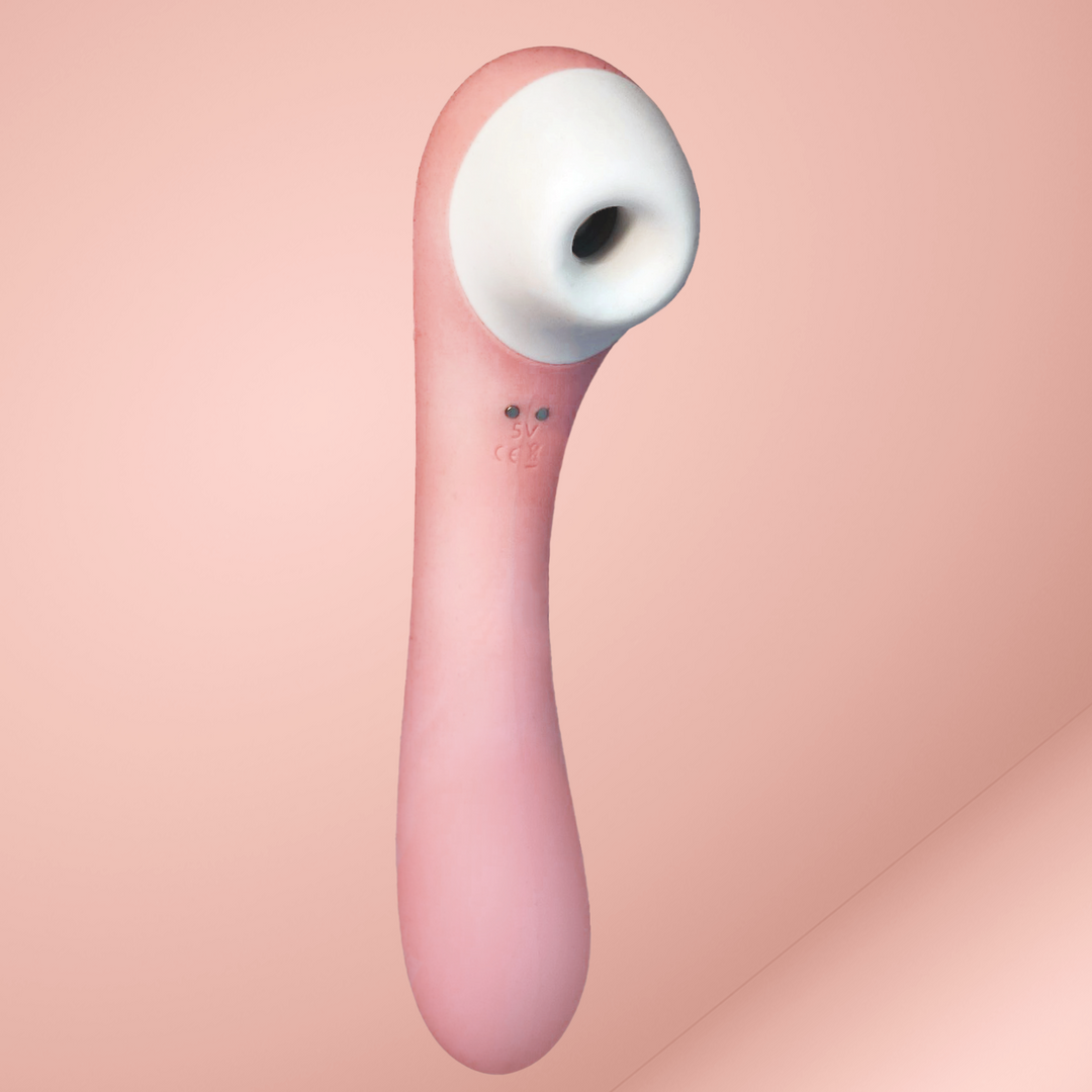 Rosa Klitorisstimulator auf rosa Hintergrund